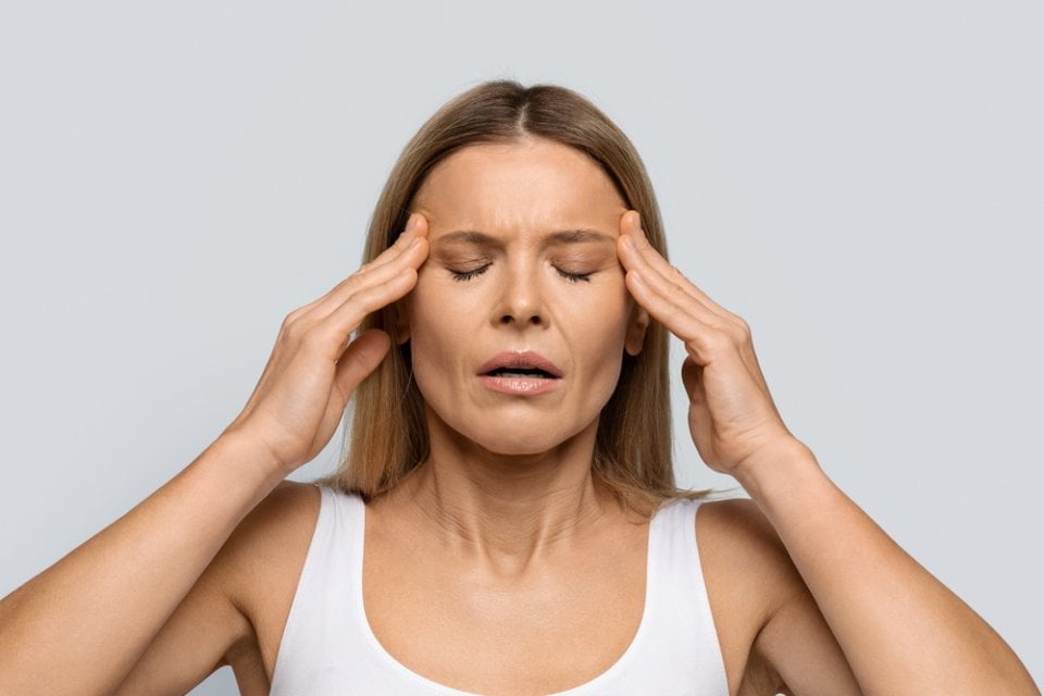 Blonde middle aged woman with closed eyes