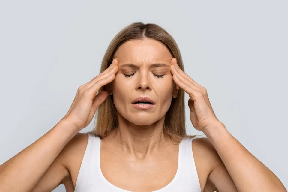 Blonde middle aged woman with closed eyes