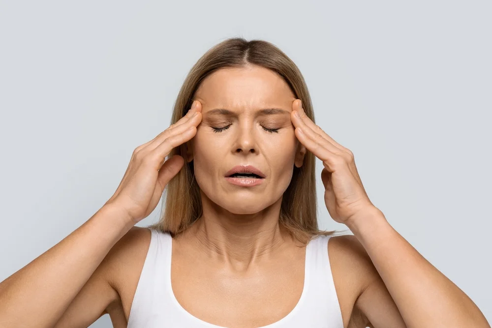 Blonde middle aged woman with closed eyes
