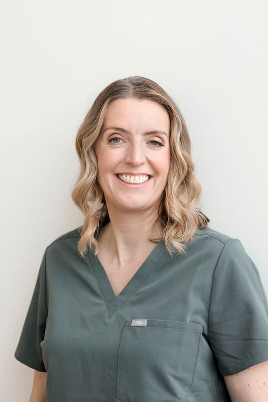 Headshot of Dr Catherine Smith wearing green scrubs