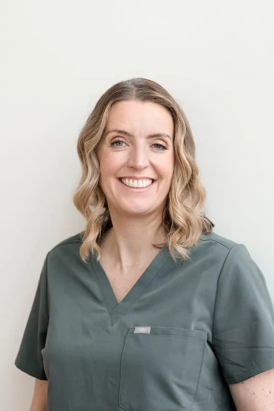 Headshot of Dr Catherine Smith wearing green scrubs